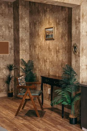 a living room with a piano and a chair at Mustang 11-11 Boutique Hotel Self Check In in Ho Chi Minh City