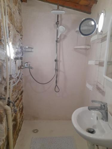 a bathroom with a shower and a sink at Stoneworld in Évdhilos