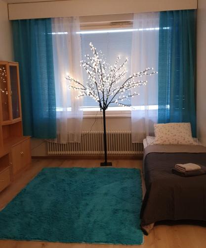 a room with a tree in front of a window at Arctic way in Sodankylä