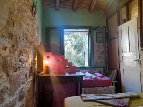 a room with two beds and a window at Stoneworld in Évdhilos