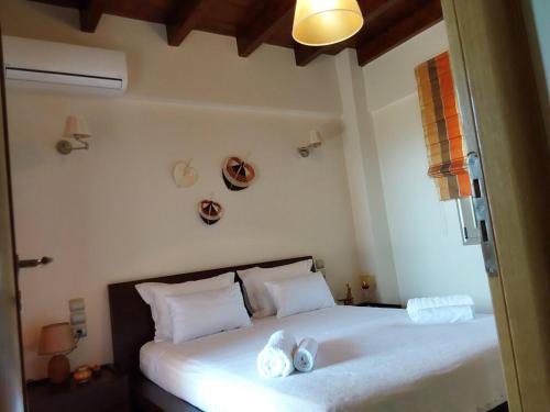 a bedroom with a bed with two towels on it at Villa Polyxeni 5 Bedrooms and Private Pool in Politiká
