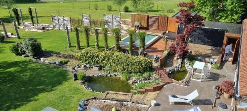 an aerial view of a garden with a swimming pool at Étang des Tamaris in Namur