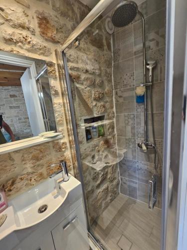 a bathroom with a shower and a sink at Gem apartment Analipsi in Hersonissos