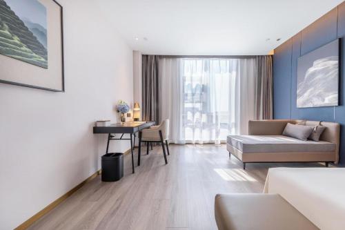 a living room with a couch and a table at Atour Hotel Beijing Capital Airport New International Exhibition Center in Beijing