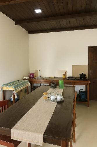 a dining room with a table with glasses on it at Stone Gate in Katugastota