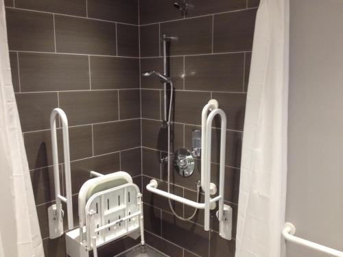 a bathroom with a shower with a shower curtain at Woodland Waters in Ancaster