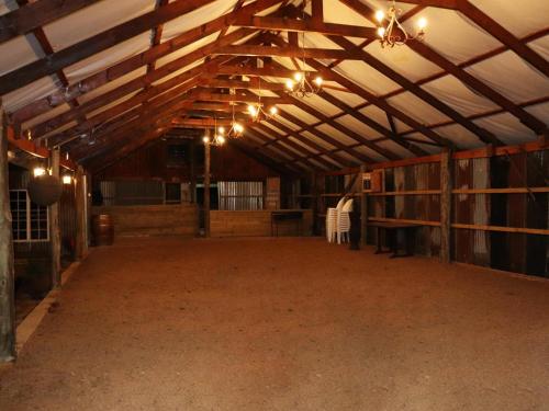 an empty barn with a large room with lights at Mount Park Guest Farm in Dargle