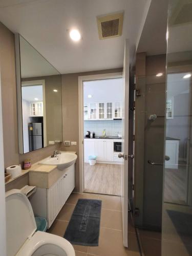 a bathroom with a toilet and a sink and a shower at The Patio See Sea 155 in Ban Bang Saen (1)