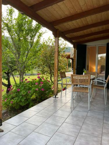 a patio with chairs and a table and flowers at Anabelis studios & apartments in Katelios