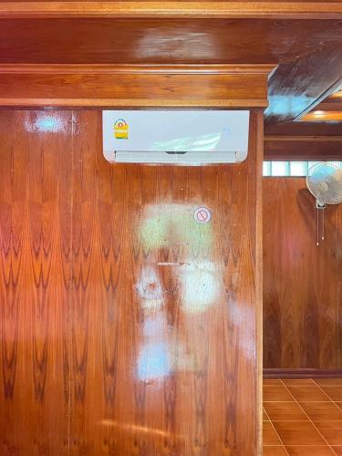 a wood paneled wall with a heater on it at Silver Beach Bungalow in Haad Yao