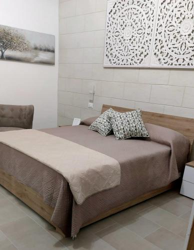 a bed with two pillows on it in a bedroom at Il Pumo Salentino in Lecce