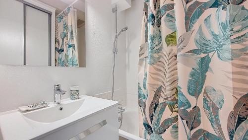 une salle de bain avec un lavabo et un rideau de douche dans l'établissement V-Landes 09-Vieux Boucau Joli appartement pour 6 personnes avec terrasse dans résidence avec piscine, à Vieux-Boucau-les-Bains