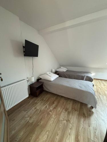 Postel nebo postele na pokoji v ubytování Zielona Osada Apartamenty