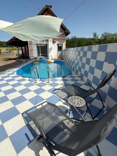 a swimming pool with a chair and an umbrella at Villa Mali san 