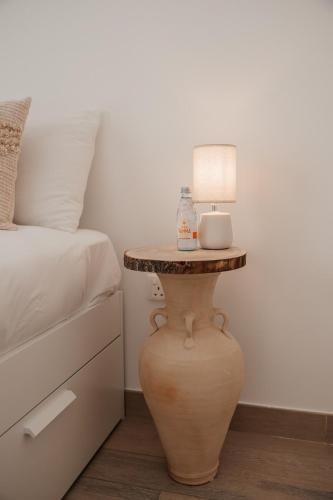 a table with a lamp on it next to a bed at Desert Home Abu Dhabi in Abu Dhabi