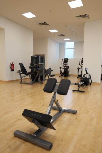 a gym with several exercise bikes in a room at Desert Home Abu Dhabi in Abu Dhabi