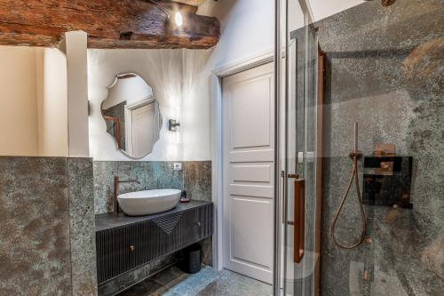 a bathroom with a sink and a mirror at Madama Lucrezia - Fontana di Trevi & Pantheon in Rome