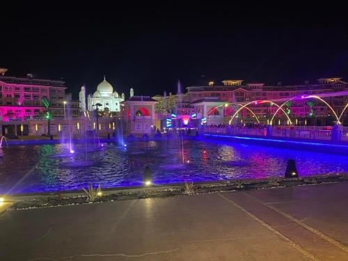 a fountain in front of a building at night at Elegant Apartments & Aquapark - B&B- FREE WI-FI-Sharm El Sheikh in Sharm El Sheikh