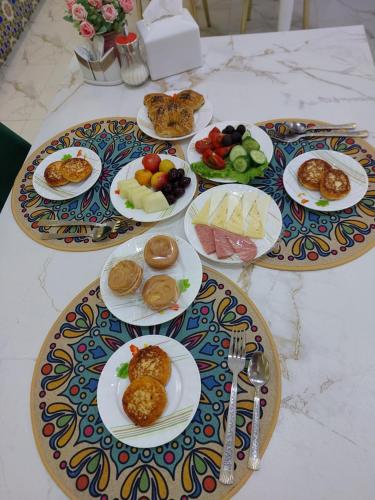 una mesa con platos de comida encima en Gulnaraxanum Hotel Boutique, en Bukhara