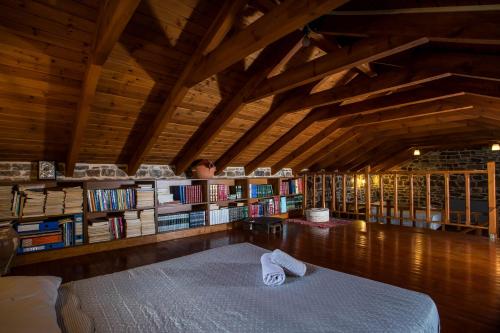 a room with a bed and a book shelf with books at Echo Traditional House - Ηχώ Παραδοσιακό Σπίτι in Émbonas