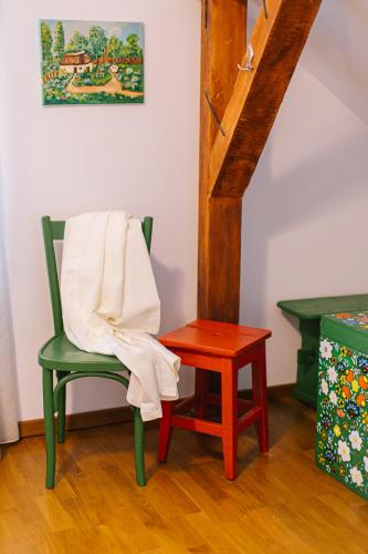 a chair and a table with a towel on it at Pensiunea Tania-Nora in Alexandru cel Bun 