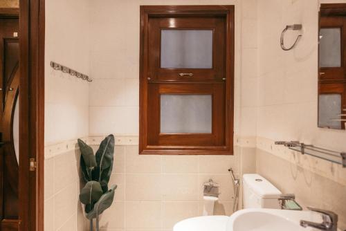 a bathroom with a sink and a toilet and a window at Mustang 11-11 Boutique Hotel Self Check In in Ho Chi Minh City