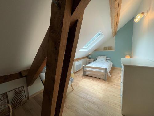 a attic room with a bed and a skylight at Loustalot in Aydius