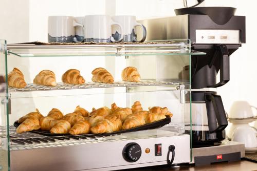 a bakery with loaves of croissants on a rack at Casa Afytos - Adults Only in Afitos