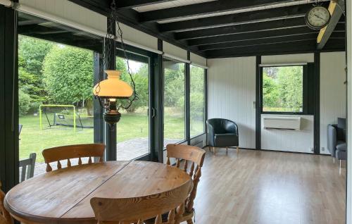 a dining room with a wooden table and chairs at Beautiful Home In Højby With Wifi in Højby