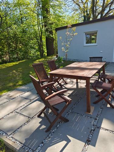 a picnic table and chairs on a patio at Two Tangerines in Milicz