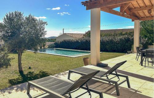 a patio with a table and chairs and a pool at Maison Avec Piscine Privée in Châteauneuf-du-Pape