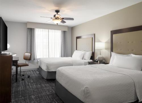 a hotel room with two beds and a ceiling fan at Homewood Suites by Hilton Akron/Fairlawn in Akron