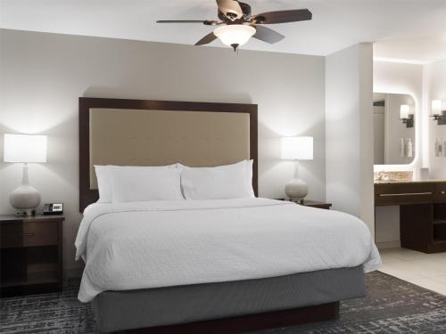 a bedroom with a large white bed with a ceiling fan at Homewood Suites by Hilton Akron/Fairlawn in Akron