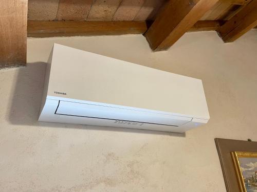 a white appliance hanging from a wall at Rustico con Jacuzzi privata BBQ e 3 camere in Montegridolfo