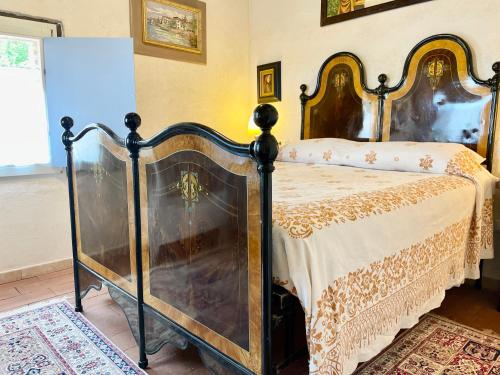 a bedroom with a bed in a room at Rustico con Jacuzzi privata BBQ e 3 camere in Montegridolfo