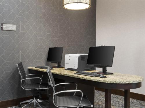 an office with two computer monitors on a desk at Homewood Suites by Hilton Akron/Fairlawn in Akron