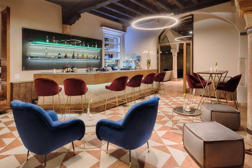 a bar with a bunch of chairs and a counter at NH Collection Palazzo Verona in Verona