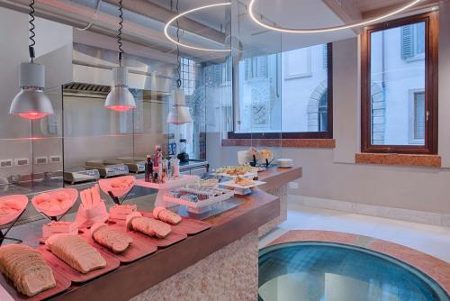 a room with a pool and a table with food at NH Collection Palazzo Verona in Verona