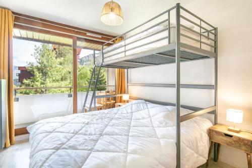 a bedroom with a bunk bed and a window at Sirius - Au coeur de la station de ski Le Corbier in Villarembert