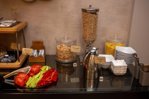 a counter top with vegetables and other food items at Nora Prestige in Timişoara
