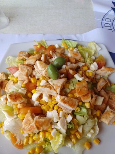 a plate with a salad with corn and other vegetables at Dimora Acqua del Fico in Castellabate