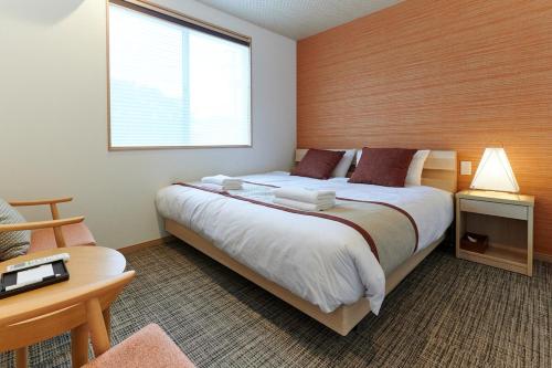 Una cama o camas en una habitación de なぎさホテル