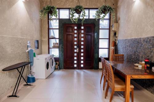 a room with a door and a table and a washing machine at Mustang 11-11 Boutique Hotel Self Check In in Ho Chi Minh City