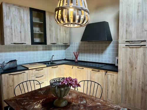 a kitchen with a table with a vase of flowers on it at Il Girasole in Chianni