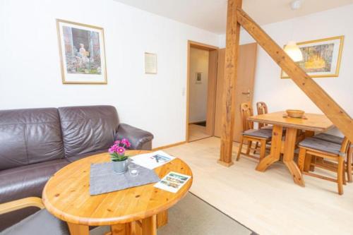 a living room with a couch and a table at Ferienwohnung Nexö, 45 qm, 1 Schlafzimmer N5 in Ilsenburg