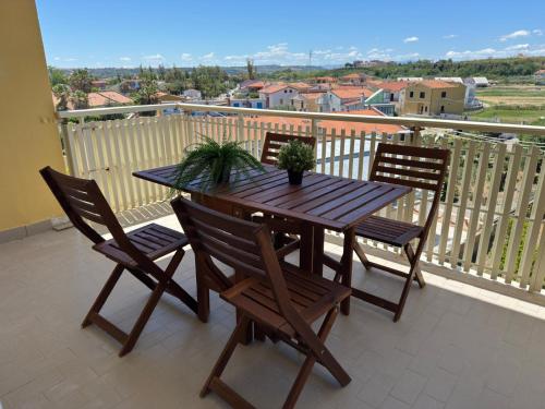a wooden table and chairs on a balcony at Sul Mare - da Angelica in Termoli