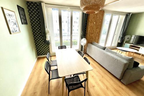 un salon avec une table, des chaises et un canapé dans l'établissement Spacious apartment - near park, à Montpellier