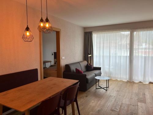 a living room with a table and a couch at Dining & Living Alpenrose in Bressanone