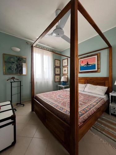a bedroom with a canopy bed in a room at Suite Casa Paola in Casa De Giorgis