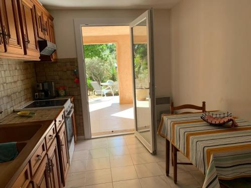 une cuisine avec une porte s'ouvrant sur une terrasse. dans l'établissement Villa de la cote bleue, à Carry-le-Rouet